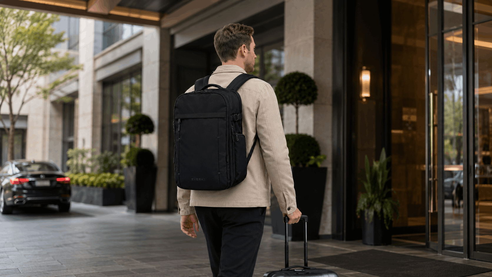 Traveler arriving at a hotel with EVERKI ONE backpack