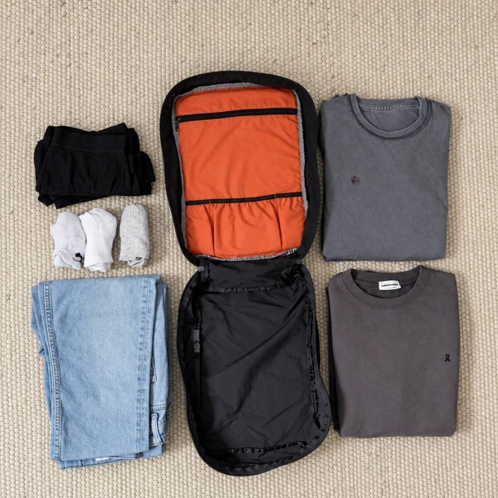 Clothes laid out around the open L-Cube