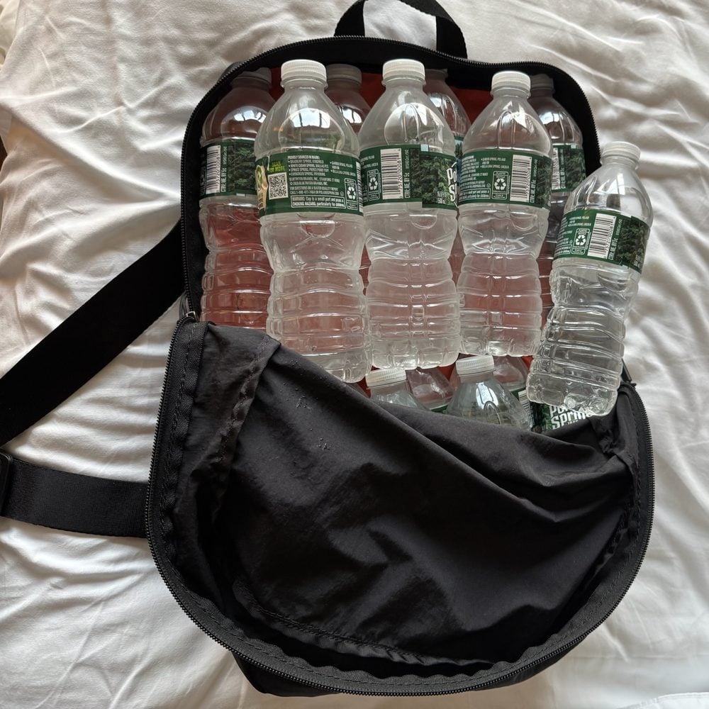 The L-Cube packed with water bottles on a hotel bed