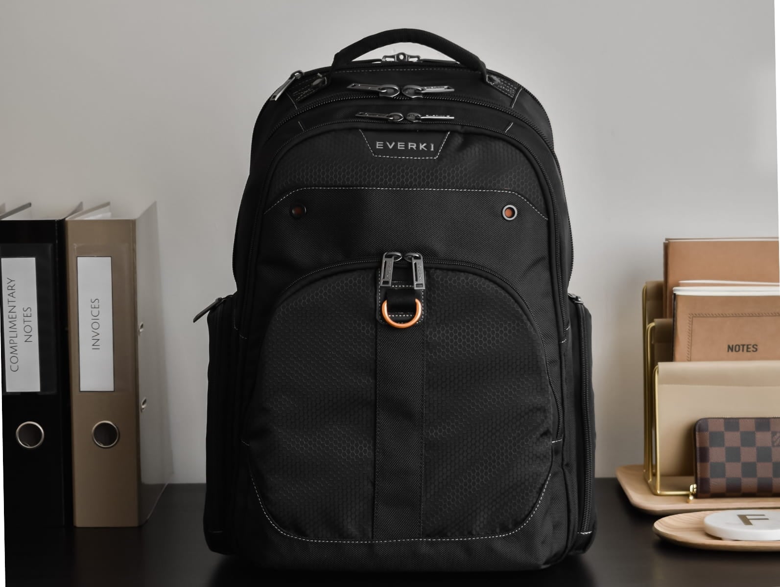 Atlas Backpack 17 shown with luggage pass-through in a travel setting